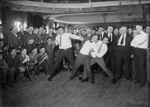 Heavyweight boxer Jack Dempsey mock punching Houdini (held back by lightweight boxer Benny Leonard)