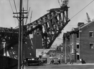 Iconic Sydney Harbour Bridge construction, showcasing human ingenuity, 1930s.
