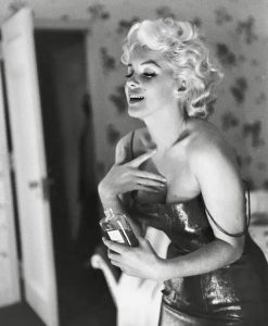 The iconic photo of Marilyn seductively applying Chanel No. 5, 1955.