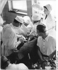 Surgeons and nurses during an operation in a hospital in Dresden, 1956.