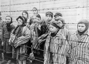Child Auschwitz survivors in oversized garb.