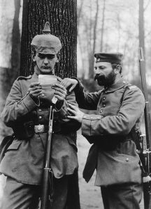 Soldiers, father and son, reading family letters at the front, 1915.