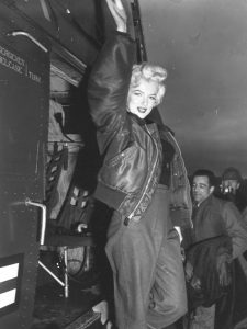 Marilyn posed beside an H-19 helicopter during USO tour in Korea in 1954.