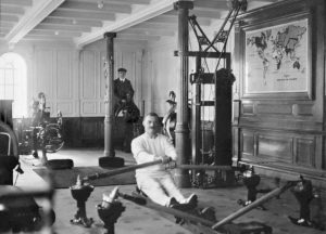 A man exercises using a rowing machine in the gym on Titanic, 1912.