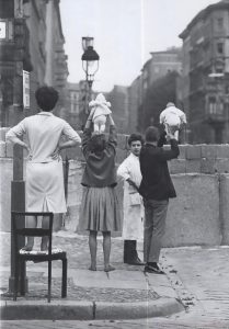 West Berlin residents show their children to East Berlin grandparents, 1961.