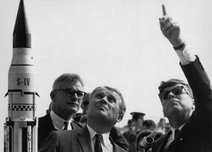 German scientist Dr. Wernher von Braun explains the Saturn Launch System to President John F. Kennedy during a visit, 1969. 