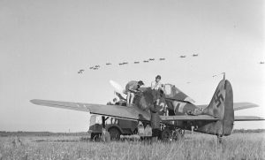 Stuka dive-bombers fly over, Immola, July 2, 1944 