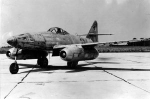 An experimental version of the Messerschmitt Me 262, the first jet aircraft, sits on an Allied airfield after its test pilot defected. (March, 1945.)