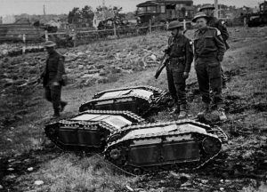 In France, British soldiers inspect three German 'Doodlebugs' (known as 'Goliath' in Germany) - remote controlled tanks, loaded with high explosives. June 1944 