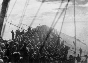 The crew of Imperial Japanese flagship Zuikaku salute the lowering of the flag as their vessel sinks. Battle of Leyte Gulf, 1944 