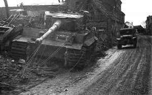 Tiger I that knocked out the first M26 Pershing in combat. It then backed into a pile of rubble and became stuck, leading to the crew abandoning it. February 26, 1945, Elsdorf,Germany