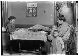 Tenement life in NYC, rolling cigarettes, 1909.