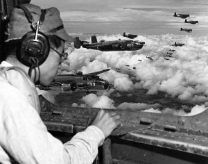 Japanese defector Lt. Minoru Wada at a B-25 waist position directs US airstrike, Philippines 1944. 