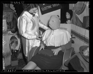 Woman wearing electric face mask, Los Angeles, 1939.