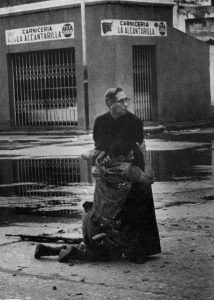 Navy chaplain Luis Padillo gives a soldier his last rites on the 4th of June, 1962 in Puerto Cabello Naval Base, Venezuela 