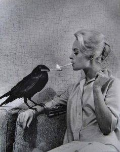 Crow lights Tippi Hedren's cigarette, on the set of The Birds, 1963.