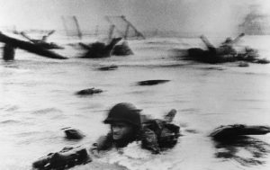 Robert Capa's famous photo of soldier struggling to survive the D-Day Invasion of Normandy, Omaha Beach, June 6, 1944 .