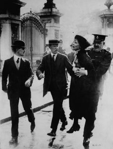 Emmeline Pankhurst being arrested outside Buckingham Palace, 1914.