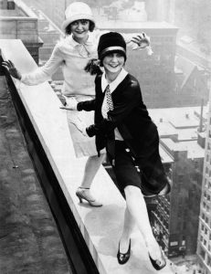 1926 Chicago: Flappers defy norms, dance on hotel rooftop.