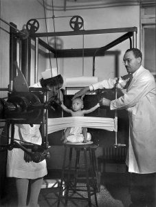 A baby undergoing X-ray with restraint, Provident Hospital, Chicago, 1942.