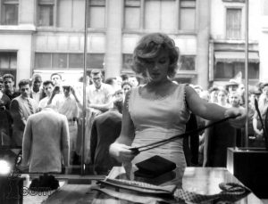Marilyn Monroe tries to go shopping while fans and media watch, 1957.