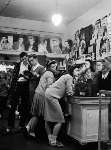 Teenagers gathered at local record store to explore the latest hits, 1940s.