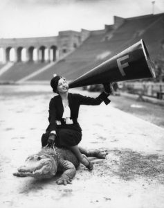 A woman riding an alligator in the Los Angeles Memorial Coliseum, 1931.