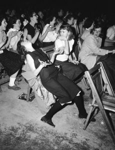 Teen Fan passionately screaming at Elvis Presley concert, 1957.