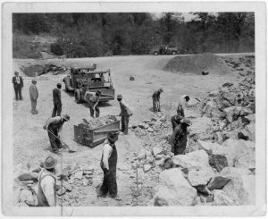 Prisoners breaking up rocks at a prison camp or road construction site, 1934. 