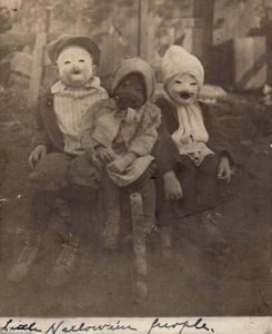 Three kids and their Halloween costumes, circa 1900s. 