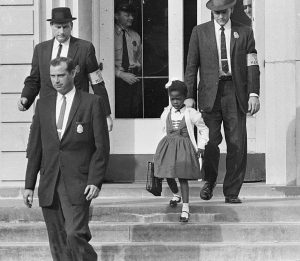 Ruby Bridges, the first African-American child to attend an all-white elementary school in the American South, escorted by U.S. Marshals dispatched by President Eisenhower for her safety. 14 November, 1960   