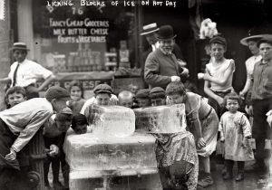 Kids cooled off with ice blocks in 1910s New York City.