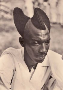 A Rwandan gentleman sporting the traditional Amasunzu hairstyle, 1923.