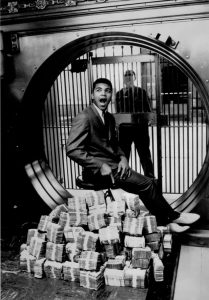 Heavyweight champion Muhammad Ali sitting on a Million Dollars, 1963.