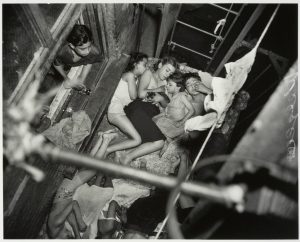 New York City kids beating the summer heat on a fire escape, 1938.