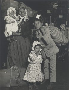 Italian family looking for lost baggage, Ellis Island, New York, 1905.