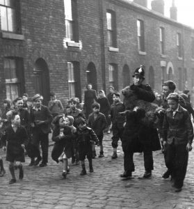 Wooly Bail Jumper: A Manchester City Police officer recovers a sheep that had made a dash for freedom, ca. 1950. 