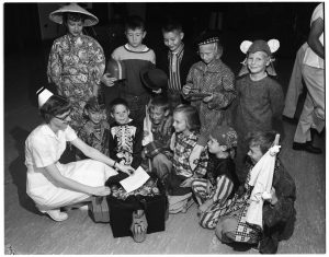 16 kids shared Halloween treats with University Hospital children, 1958.