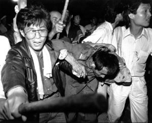 Tank driver being helped to safety during the Tiananmen Square crackdowns. June 4, 1989 