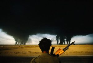 Iranian soldier watches as oil refineries burn in the outskirts of the Iranian city of Abadan in SW Iran, during the siege of the city in the Iran-Iraq war (1980-1981).  