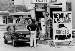 A Lada car owner struggles to refuel his vehicle In 1984 Toronto.