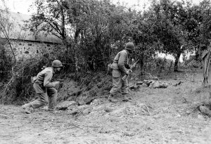 American soldiers in search of a German sniper near St. Lo (Saint-Lô), 1944 