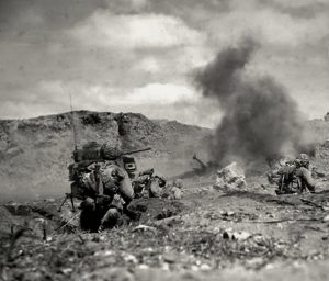 Supported by tanks, U.S. Marines stage a frontal attack on Japanese positions in the craggy ridges of northern Iwo Jima, 1945 