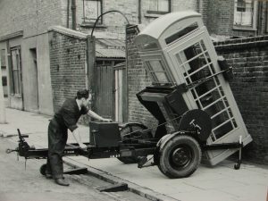 A worker installs a K6 phone box, London late 1930s. 