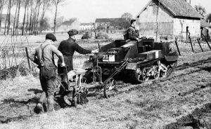 Before the Battle of France - The Royal Irish Fusiliers of the BEF come to the aid of French farmers whose horses have been commandeered by the French Army: a tank is hitched to a plow to help with the spring tilling of the soil on March 27, 1940 