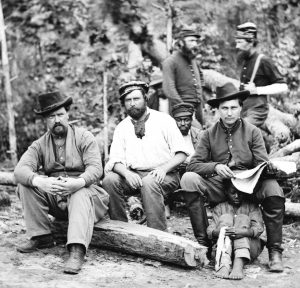 Group of people posed for a stereograph at Foller's Farm in 1862.