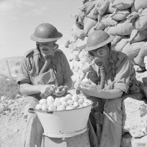 Soldiers wore gas masks for tear-free onion peeling in Tobruk, 1941.