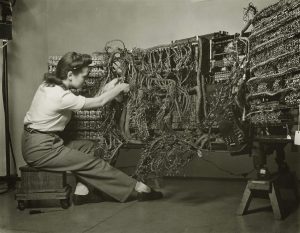 Skilled female engineer meticulously wired an IBM computer, 1958.