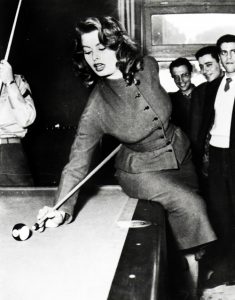 Actress Sophia Loren playing billiards with three US servicemen, 1950s.