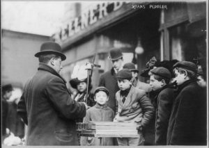 Selling Christmas joys in steely New York City streets, 1910.